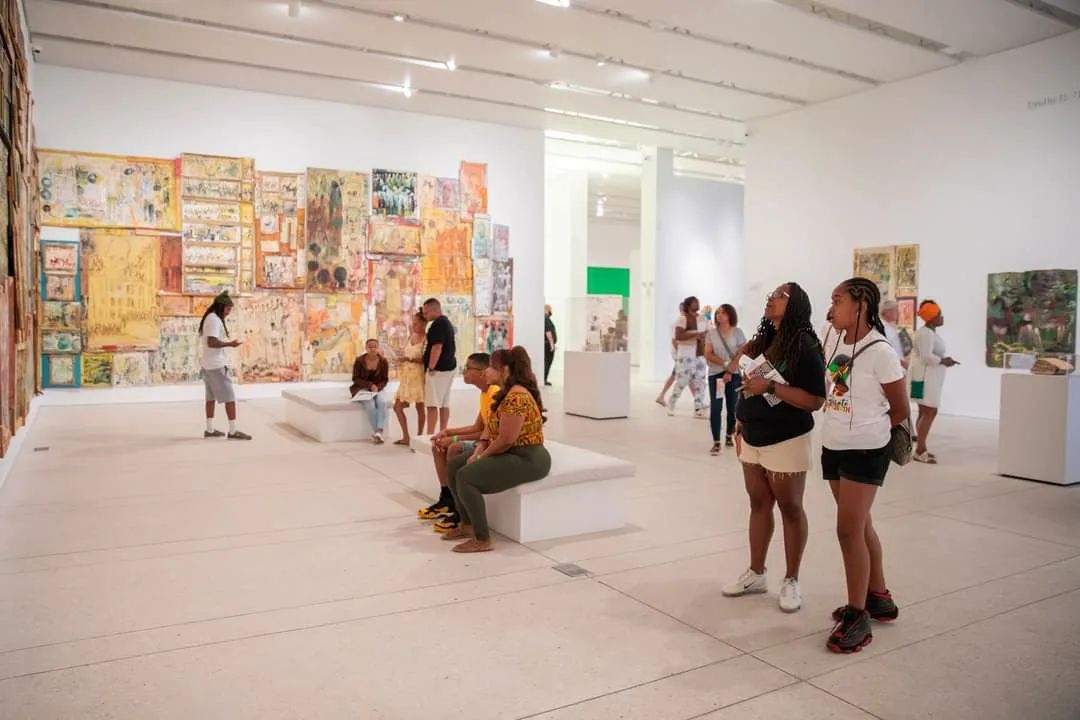 A group of people admires painting art in the Tampa Museum of Art. Photo by Instagram user @tampamuseumofart