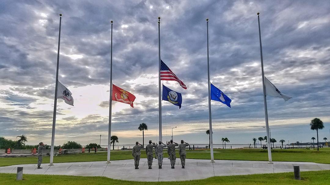 Air force members saluting flags at MacDill AFB. Photo by Instagram user @macdillafb