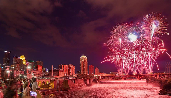 Red fireworks going off above Minneapolis for the Water Festival. Photo by Instagram user @aquatennial