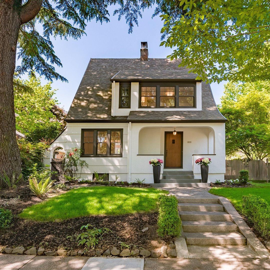 White house with grey roof during daylight in Alameda, Portland. Photo via Instagram username @thebungalowguy