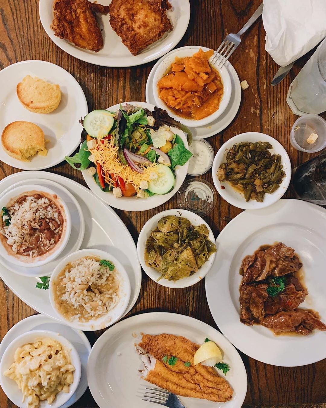 Table full of fried catfish, cornbread, and rice from Willie Mae's. Photo by Instagram user @williemaesnola