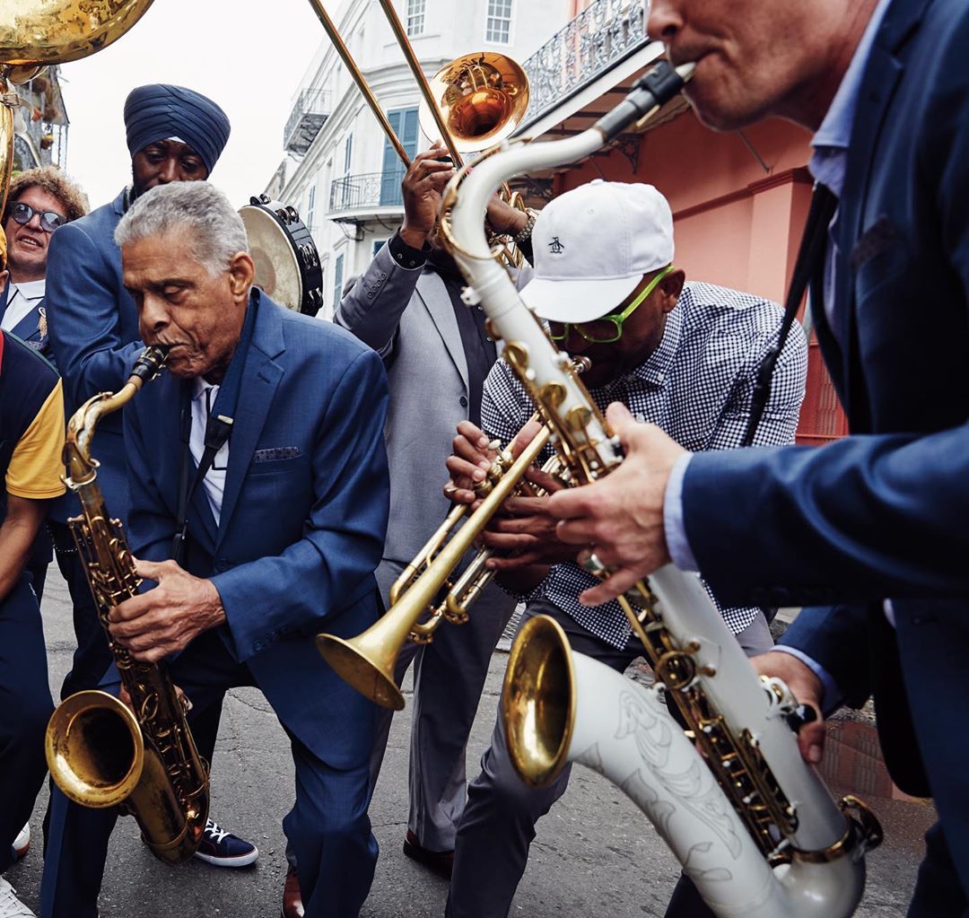 Group of men playing the saxophone on the street. Photo by Instagram user @originalpenguin