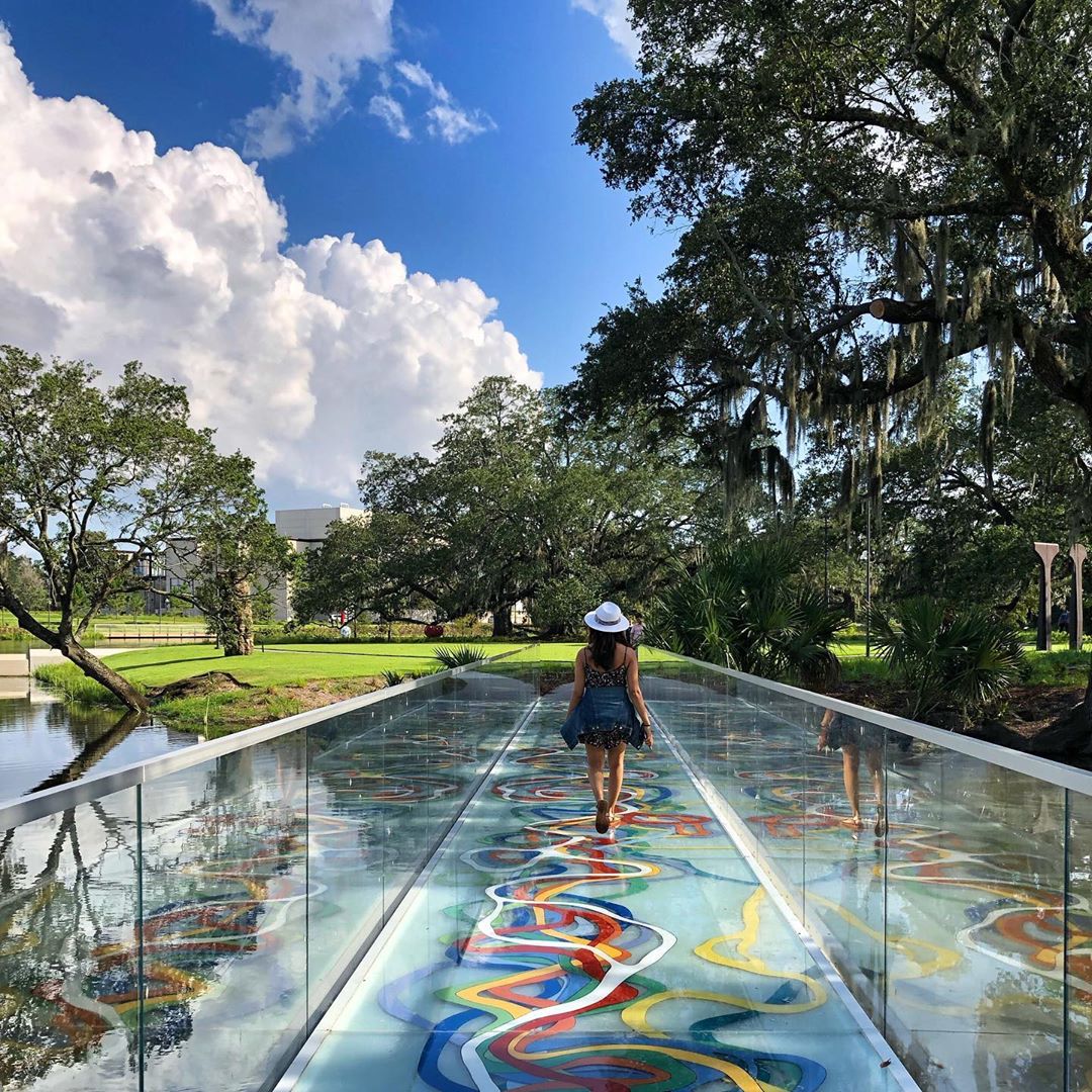 Girl walking on painted glass bridge. Photo by Instagram user @voyageurchic