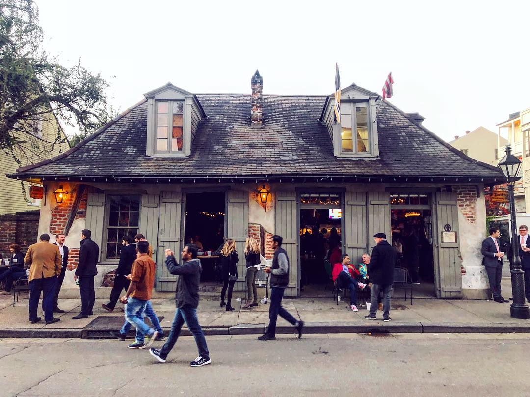 People walking in front of a bar that looks like a house. Photo by Instagram user @scottshilstone