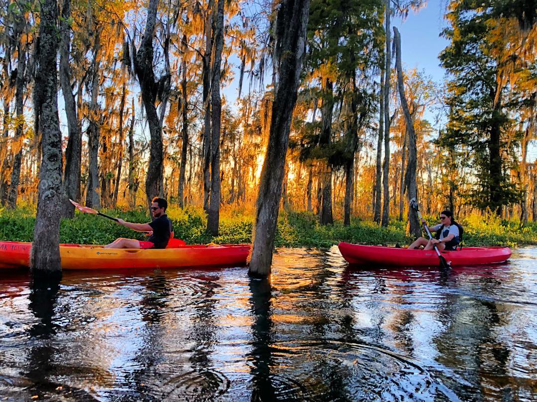 Two people kayaking in a river. Photo by Instagram user @kayaknola