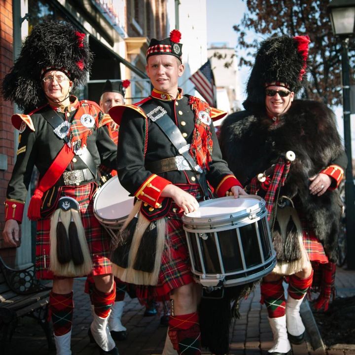 A group of tartan-clad musicians marching in the Scottish Christmas Walk Parade. Photo by Instagram user @visitalexva.