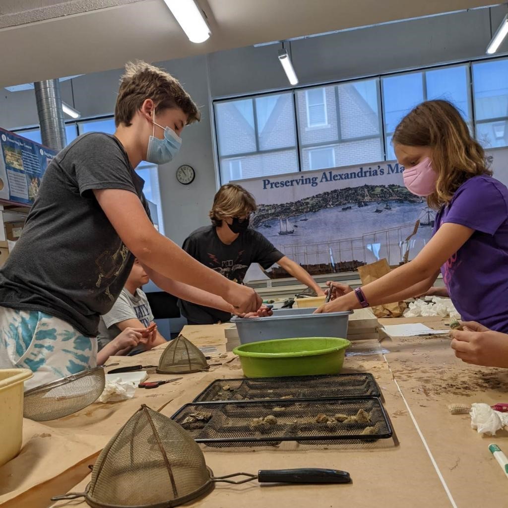 A group of children washing and sorting artifacts they excavated at the Alexandria Archaeology Museum. Photo by Instagram user @alexandriaarchaeology.