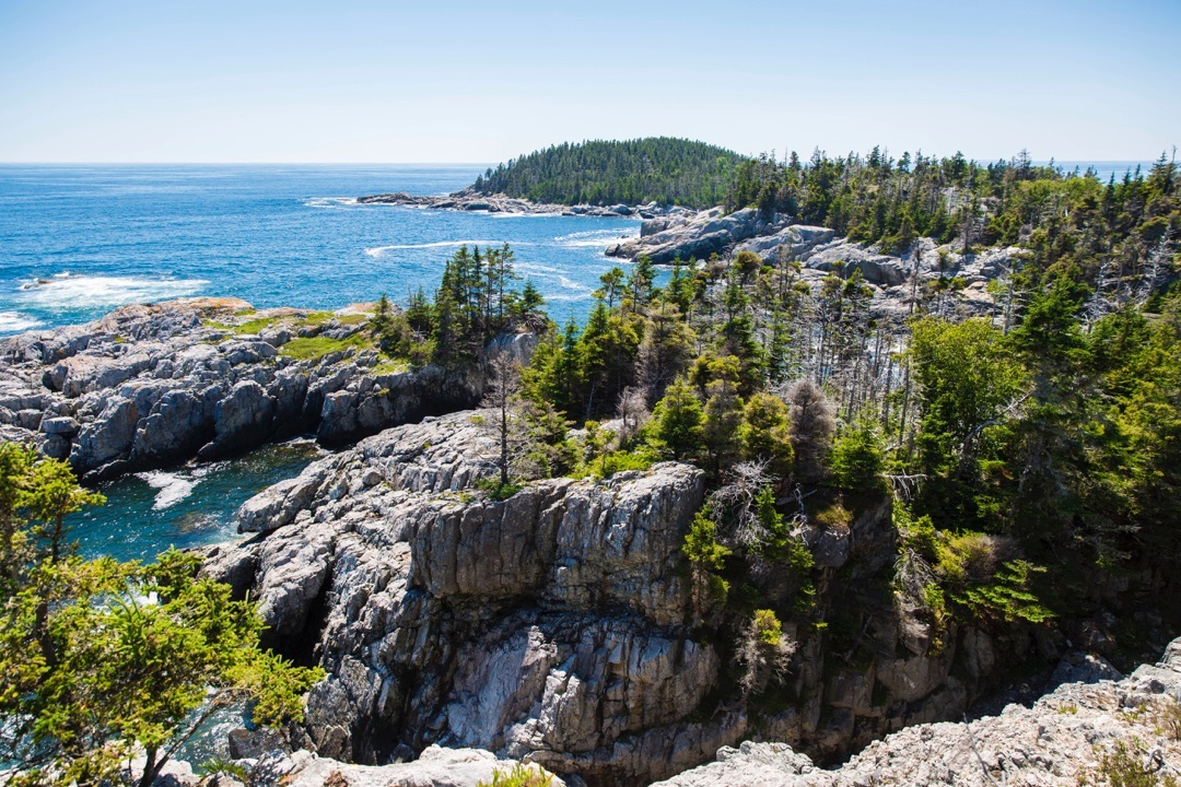 Top of a mountain overlooking bright blue water at Acadia National Park,ME. Photo by Instagram user @acadianps 