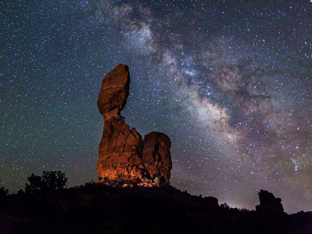 Red rock formation under a starry sky at Arches National Park, UT. Photo by Instagram user @colindyoungphotography