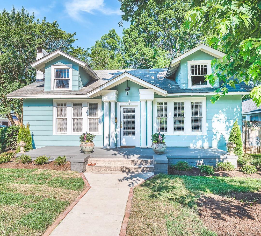 Baby blue house with white trim and white door in Elizabeth, Charlotte. Photo by Instagram user @gwrealestate