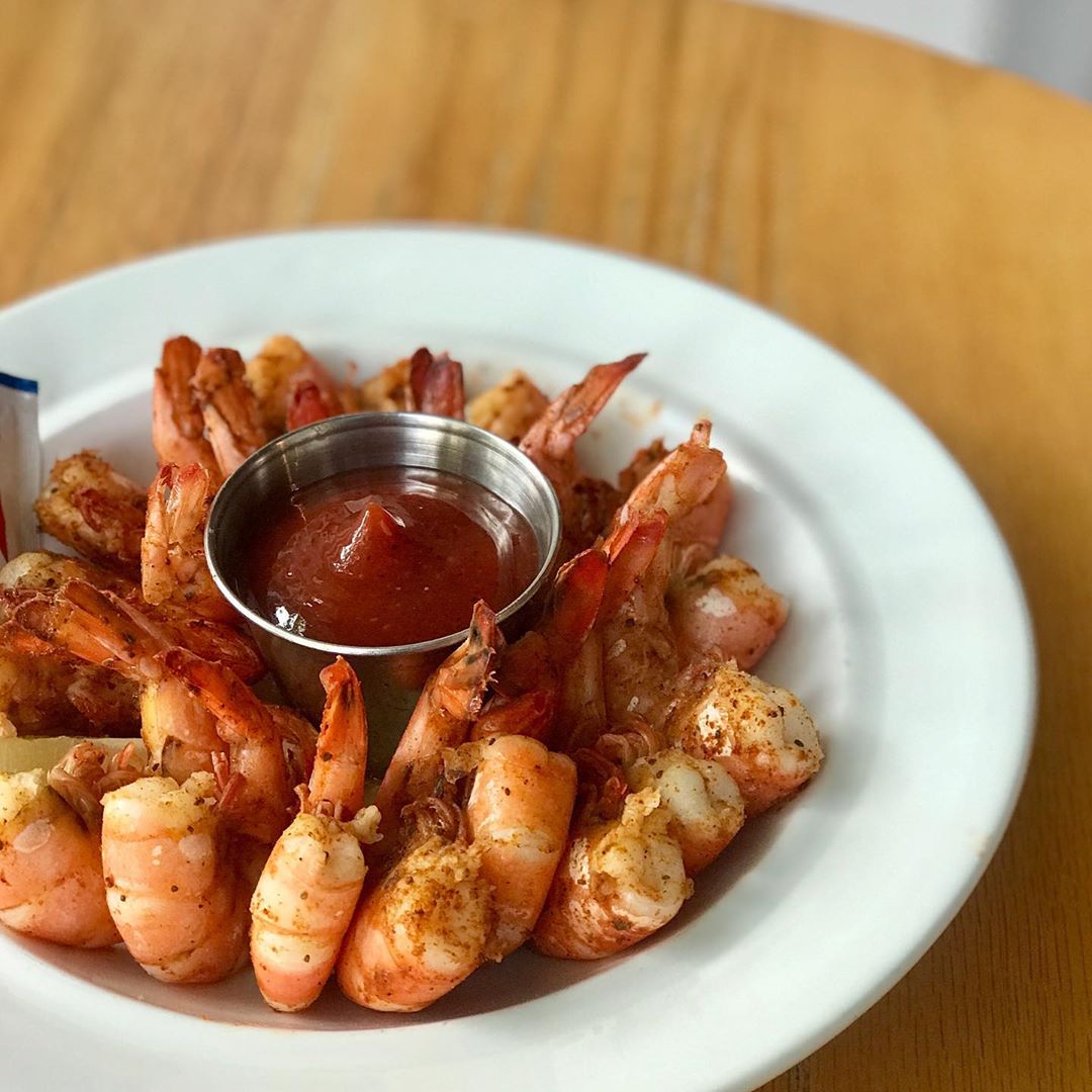 Shrimp in a bowl with sauce. Photo by Instagram user @hanksoysterbar