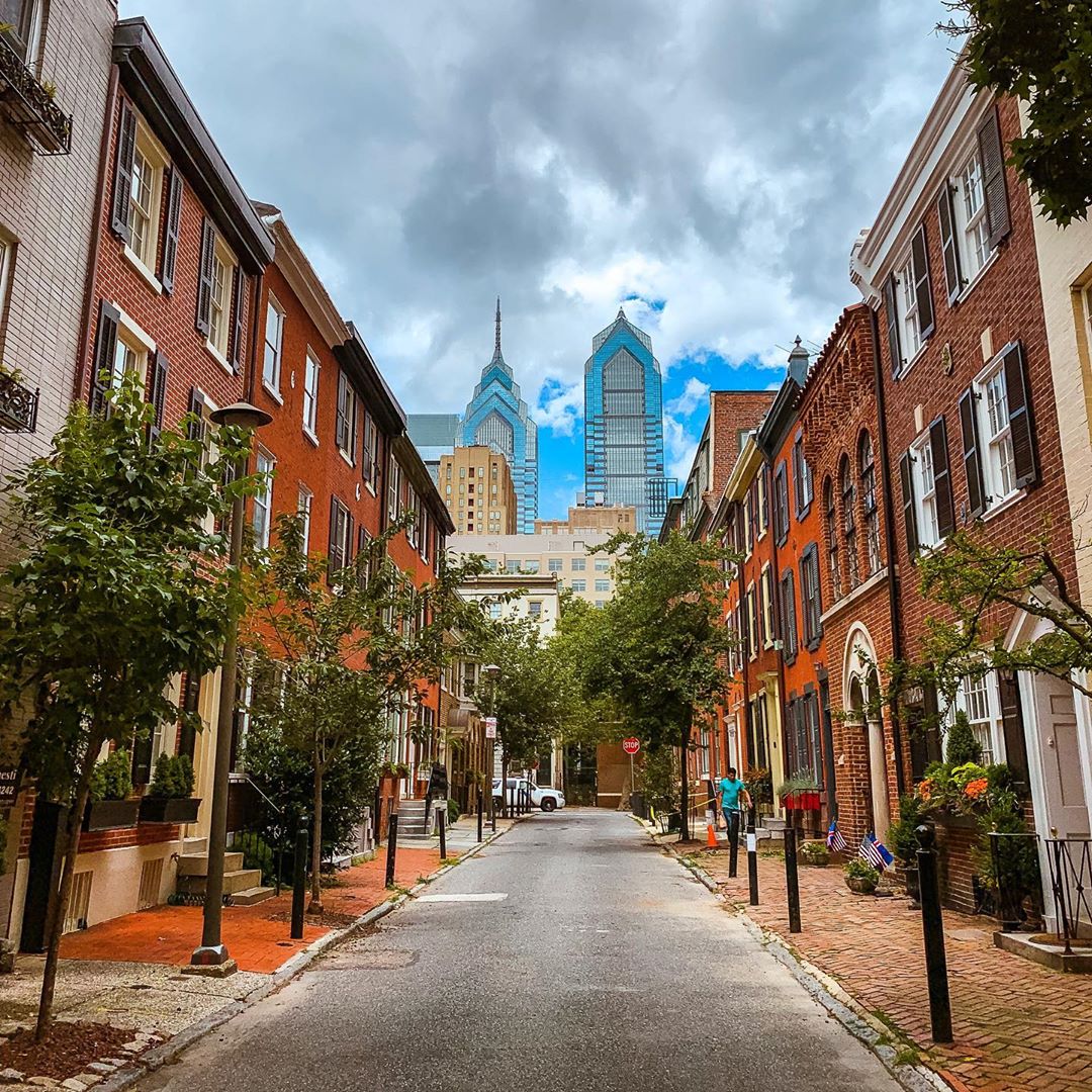 Street view of red brick rowhouses. Photo by Instagram user @phillyperspective