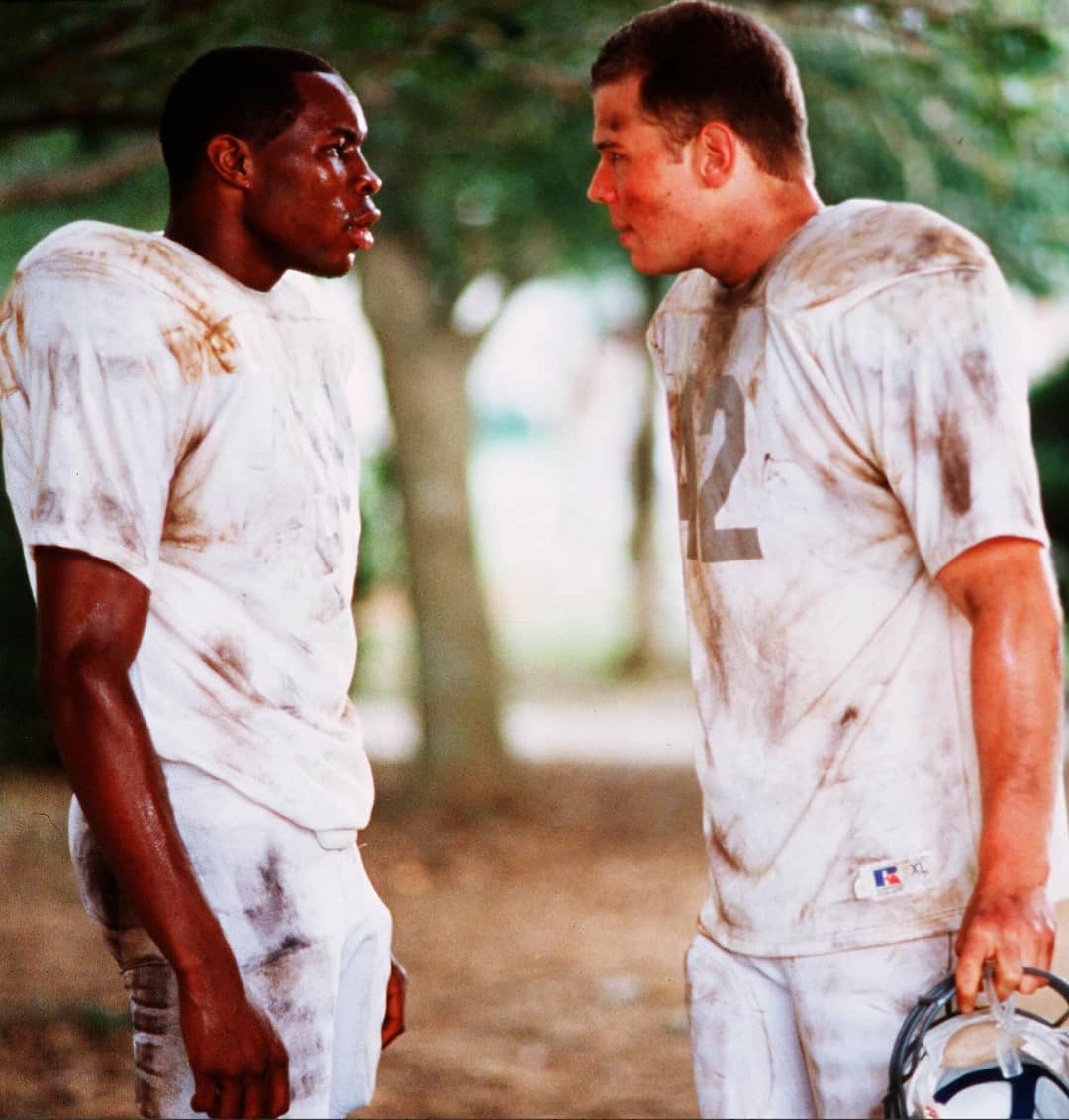 White football player and African football player talking from Remember the Titans. Photo by Instagram user @aleshashinobi