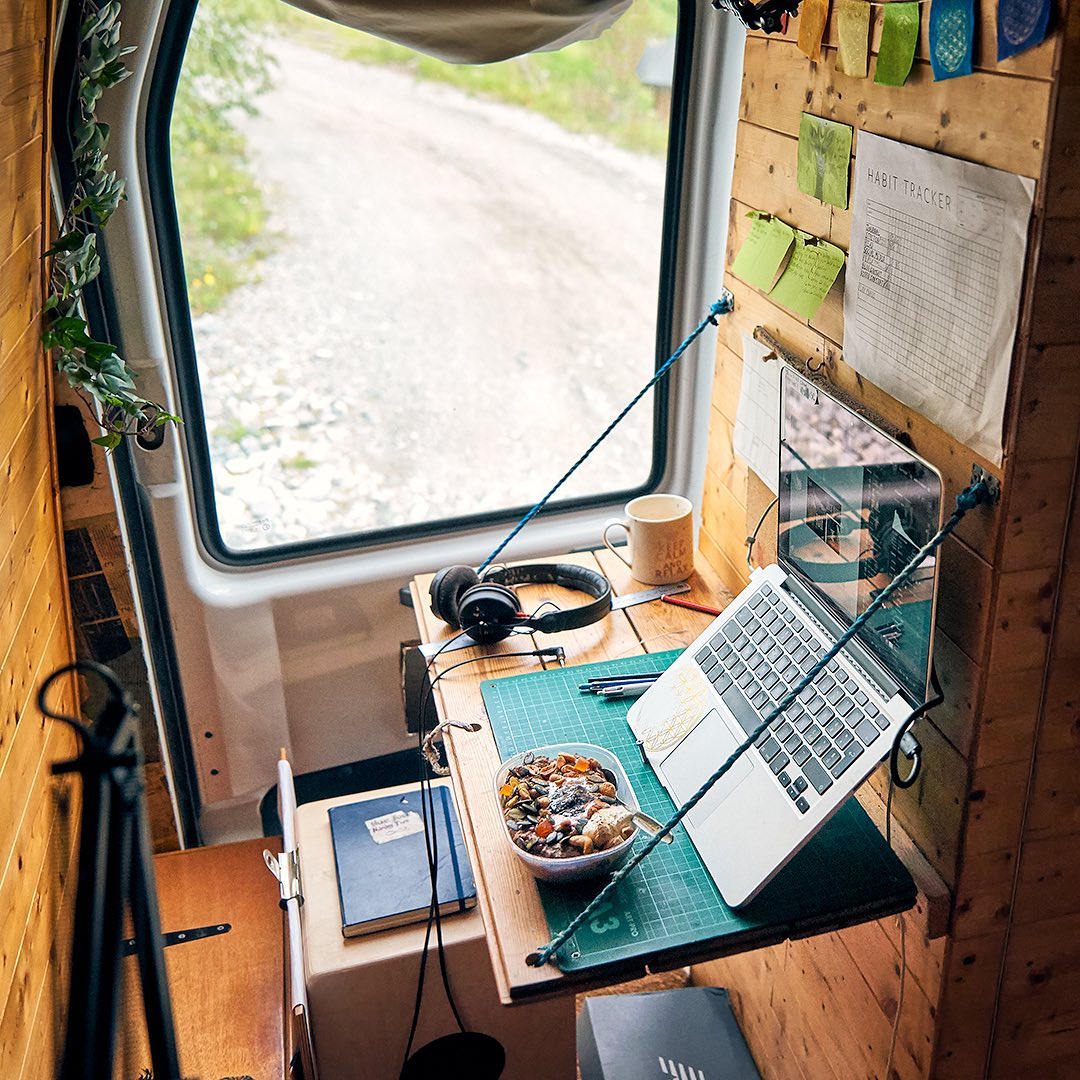 Computer at a desk in a van. Photo by Instagram user @vandogtraveller
