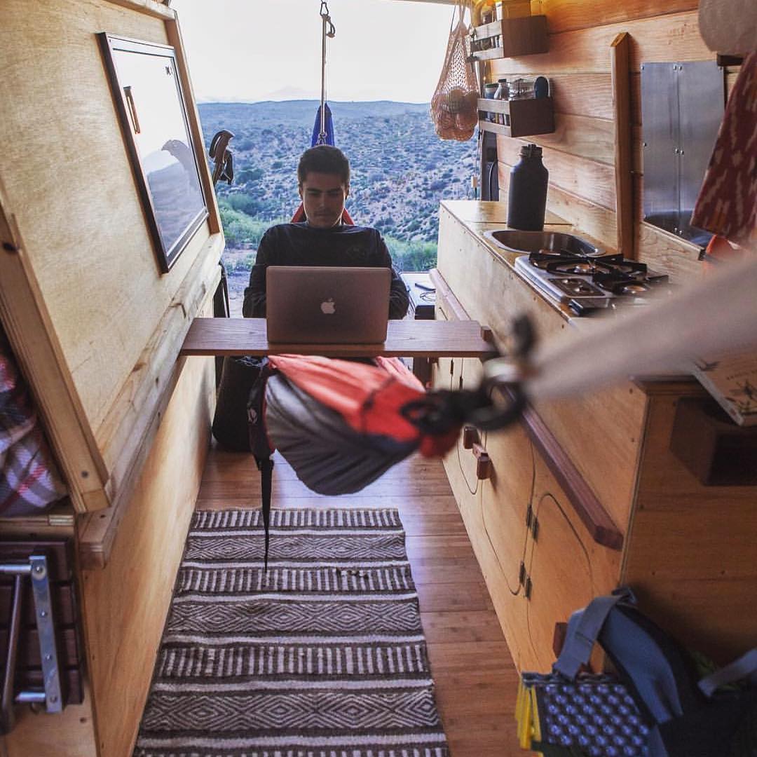 Guying hanging in a hammock in his van while working. Photo by Instagram user @cyrus_sutton