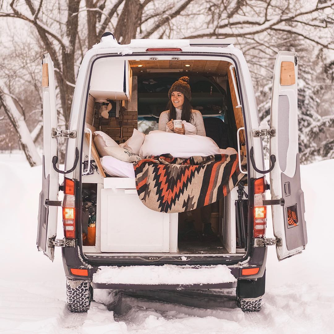 Girl sitting in the back of a van in winter. Photo by Instagram user @rebeccamoroney