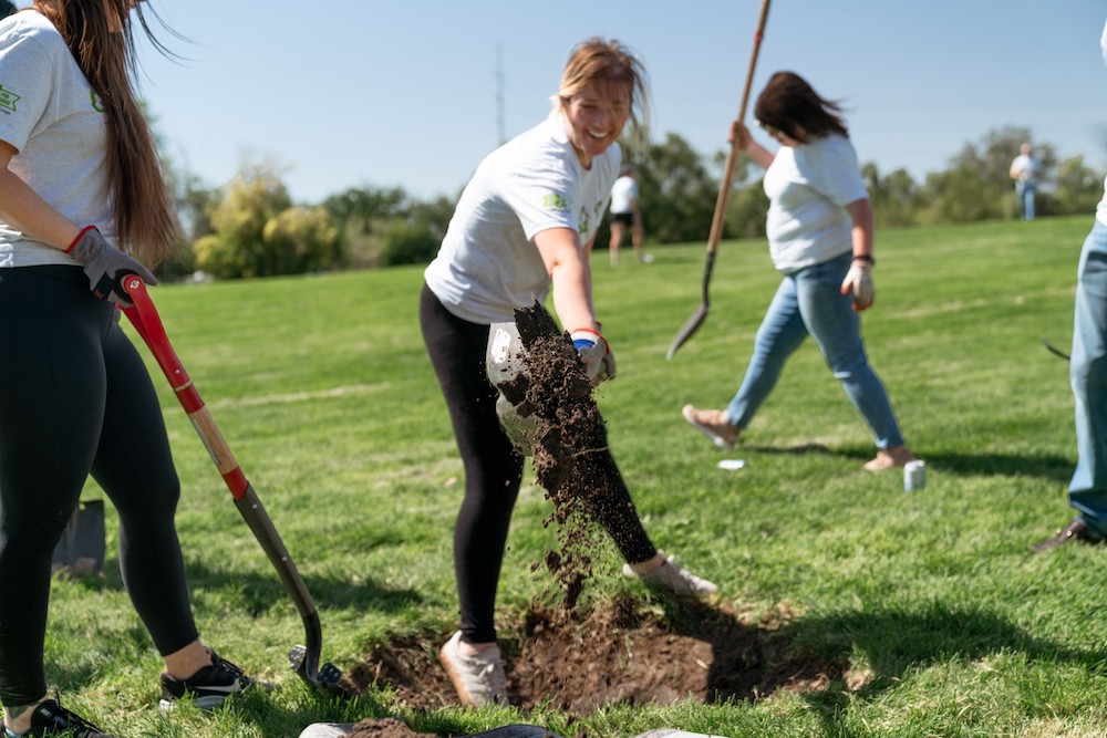 Extra Space Storage team members shovel spots for trees in Constitution Park, Salt Lake City, UT