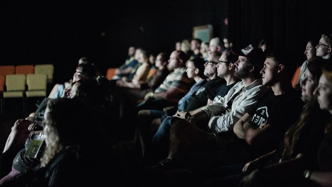 People sitting in a theater watching a movie at the Sidewalk Film Festival. Photo by Instagram user @sidewalkfilm