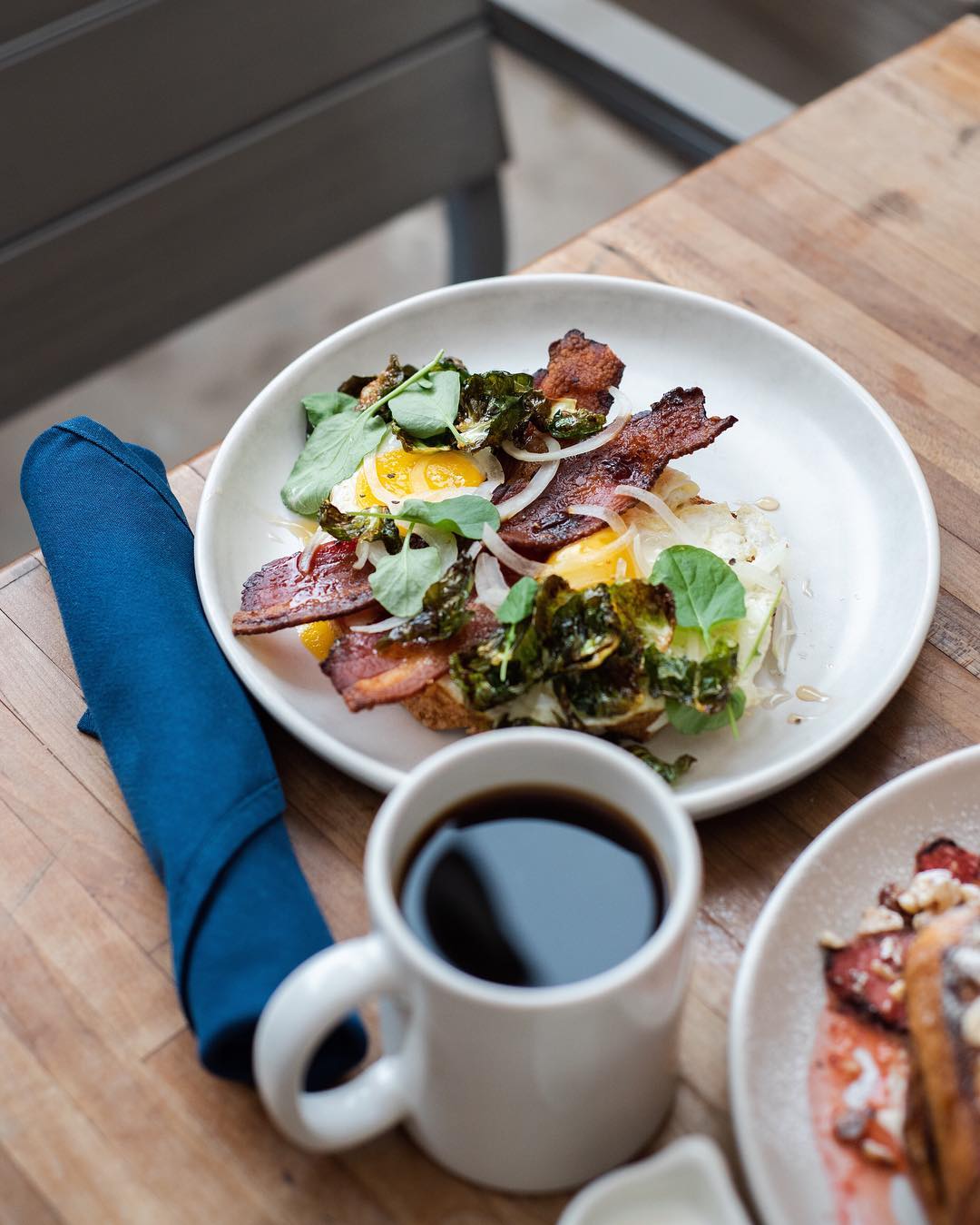 Plate of bacon and eggs with a coffee. Photo by Instagram user @prepandpastry