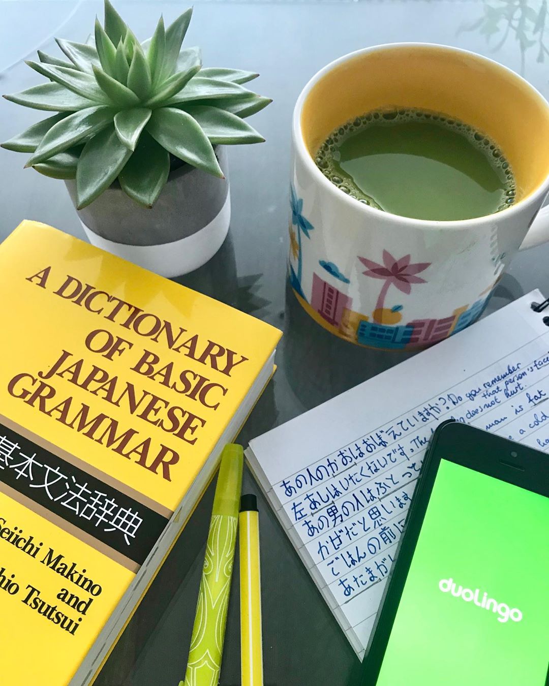 Cup of tea and Japanese language book. Photo by Instagram user @zarryb