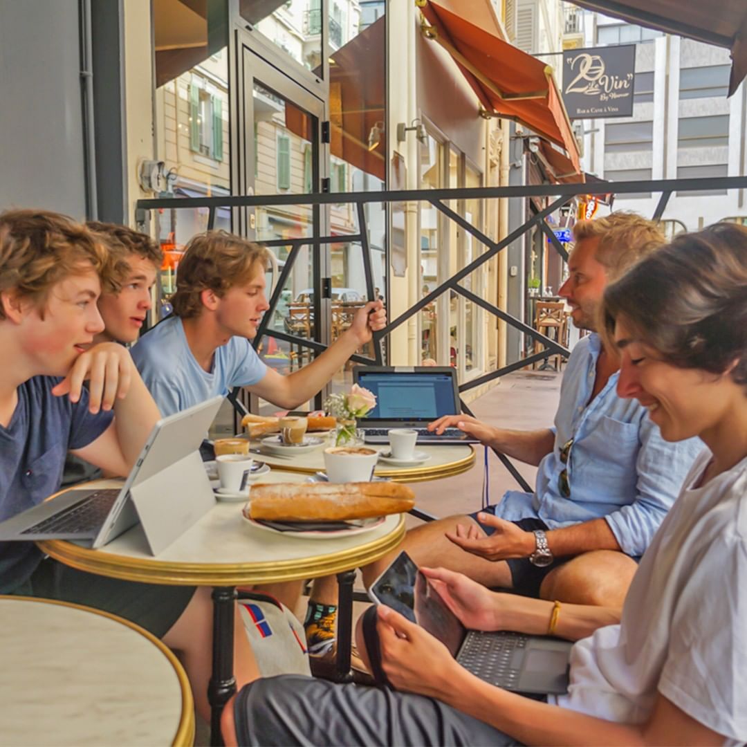 Group of guys eating and talking. Photo by Instagram user @blythacademyinternational