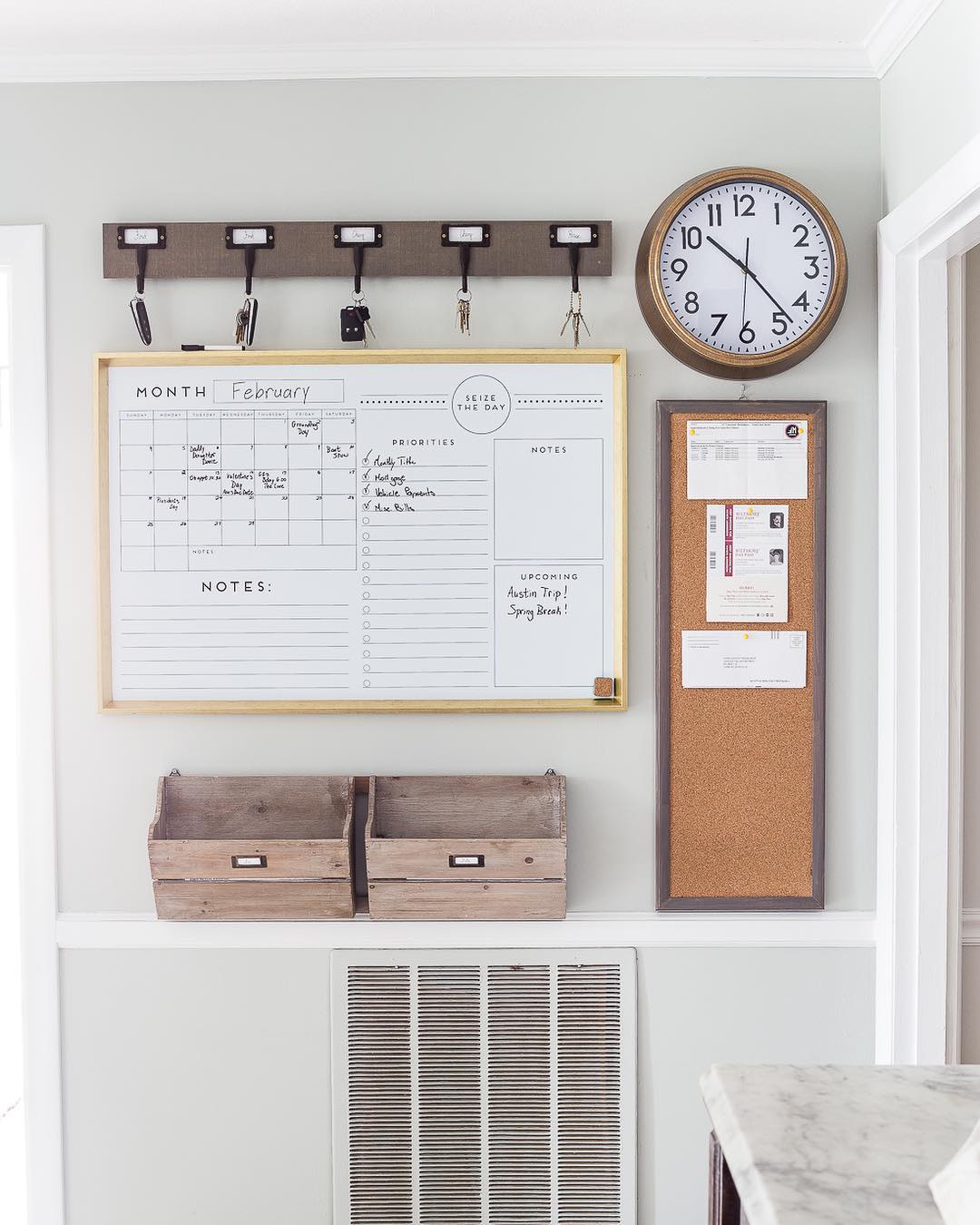 Calendar and clock and hooks on a wall. Photo by Instagram user @organizerjanet