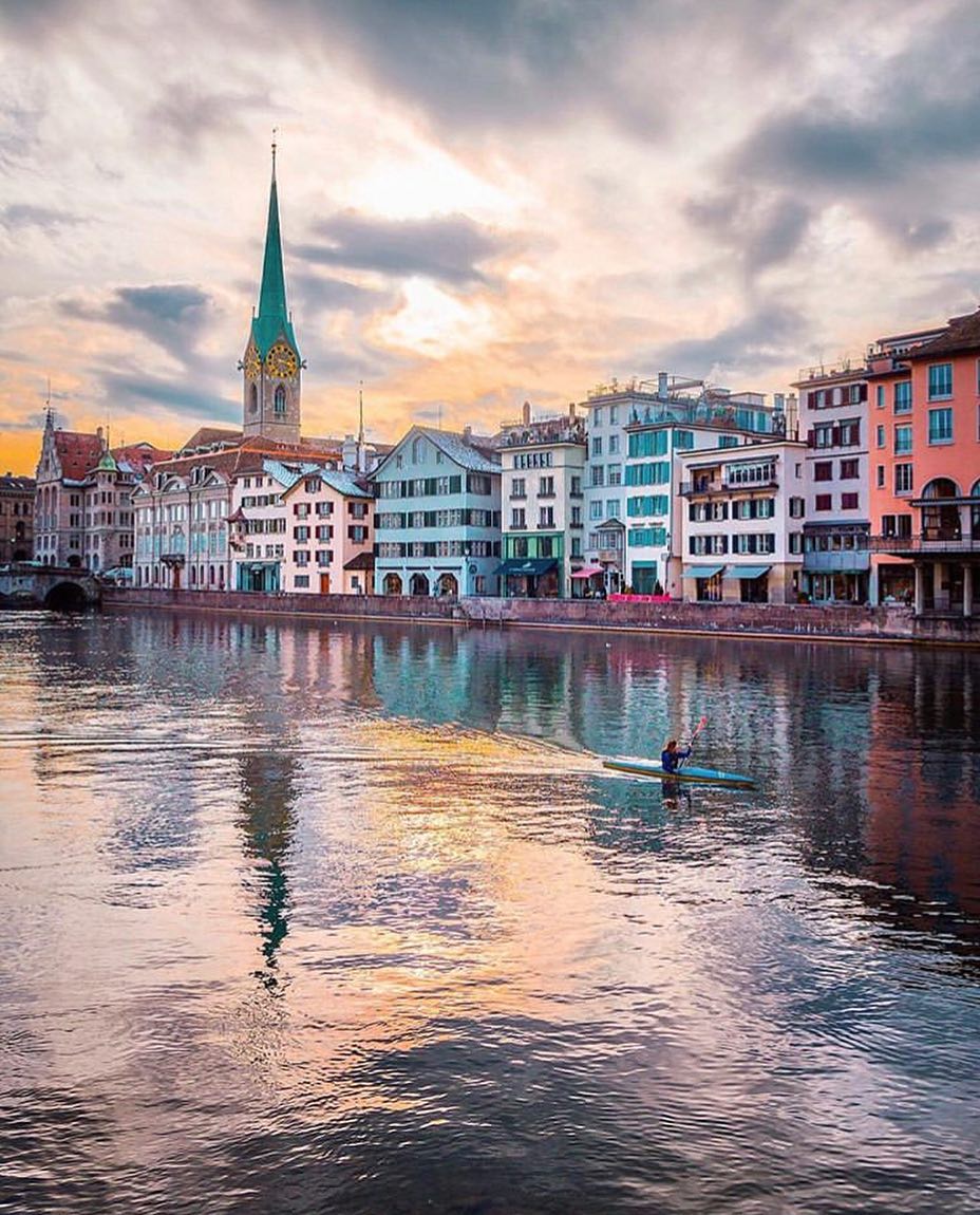 Colorful buildings next to a river in Zurich. Photo by Instagram user @christofs70