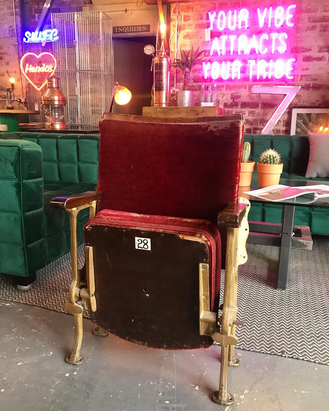 Red theater chair in an antique store. Photo by Instagram user @7hillsreclamation