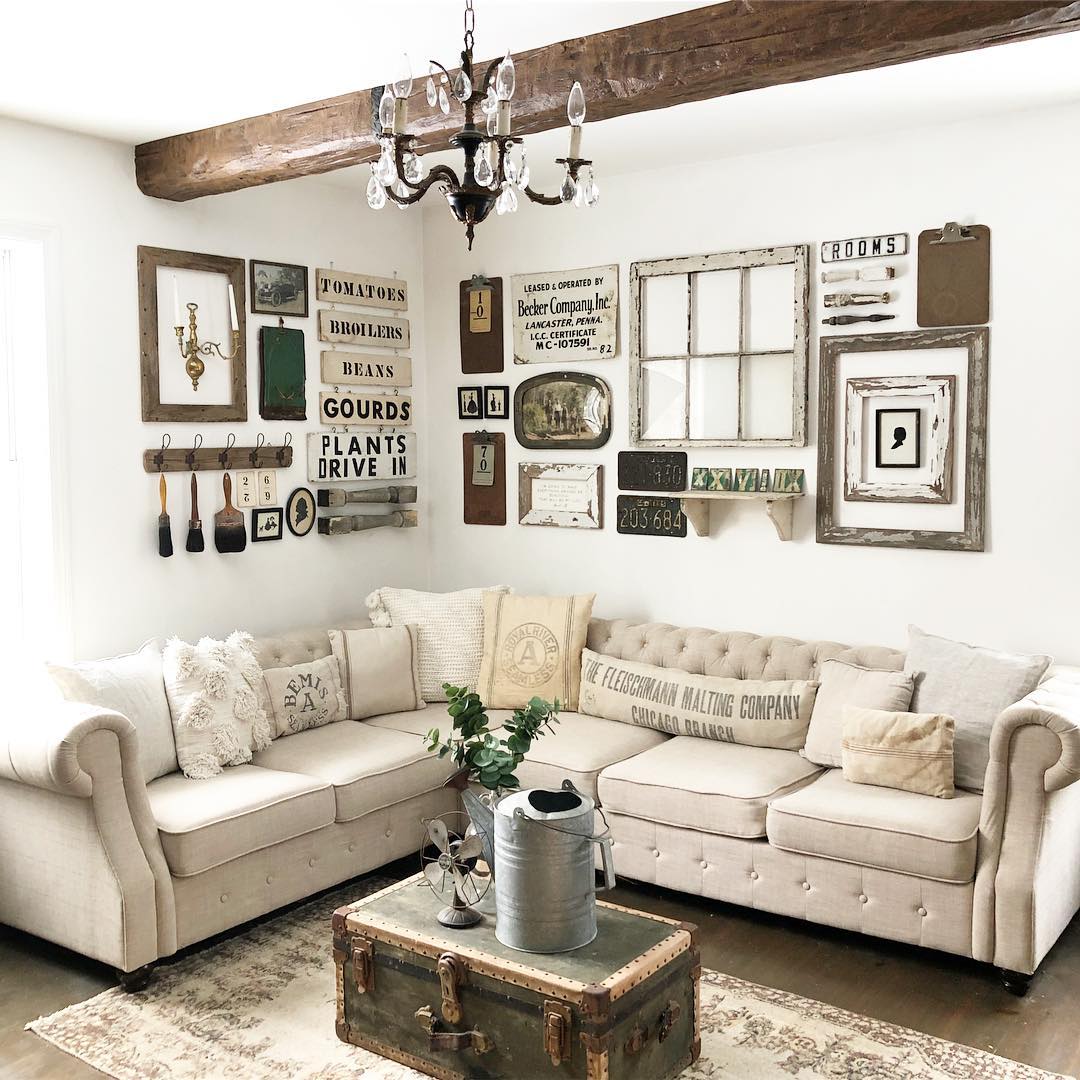 Living room with white walls. cream couch, and tan decor. Photo by Instagram user @thelittlefarmhouse