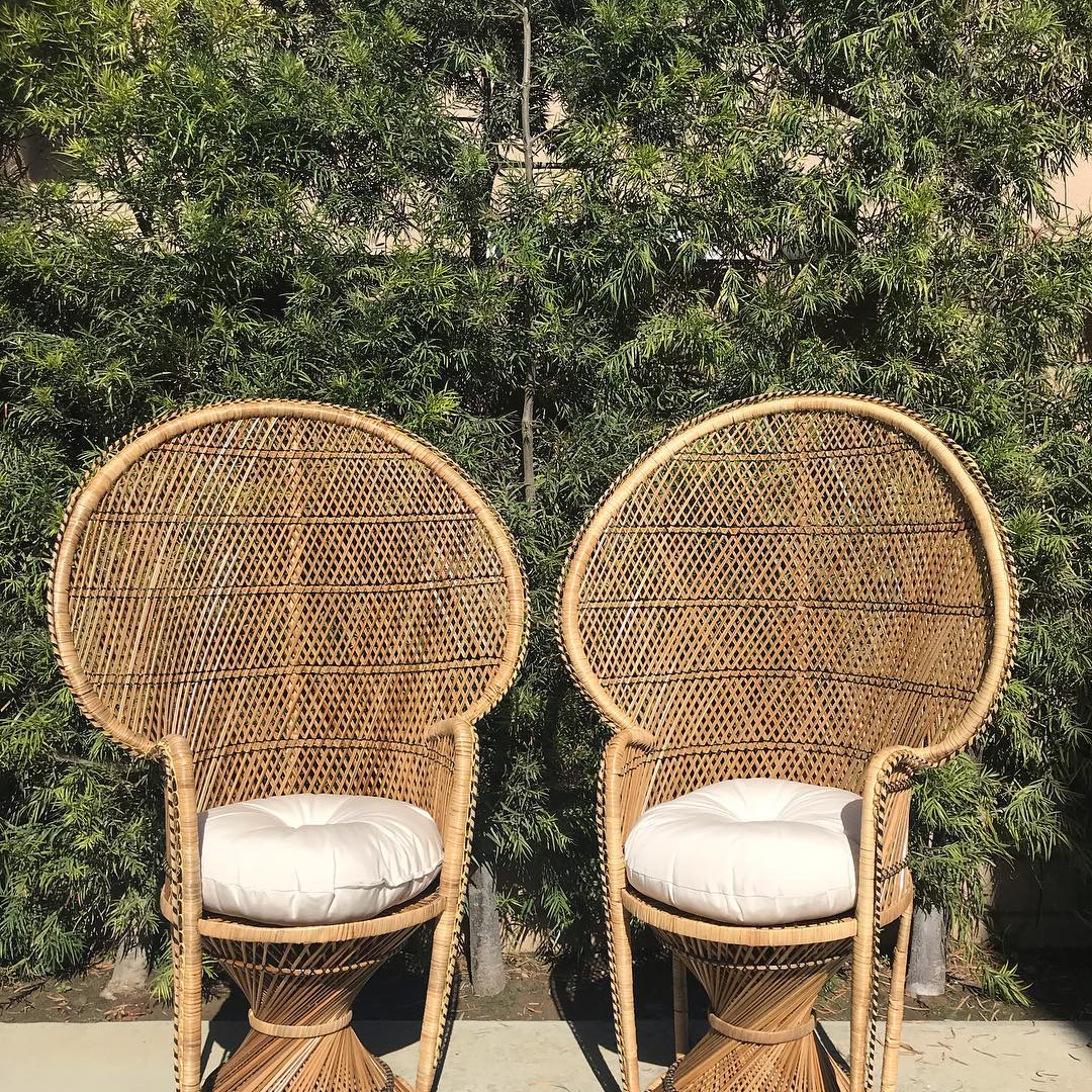 Two brown wicker peacock chairs. Photo by Instagram user @dejavidecors