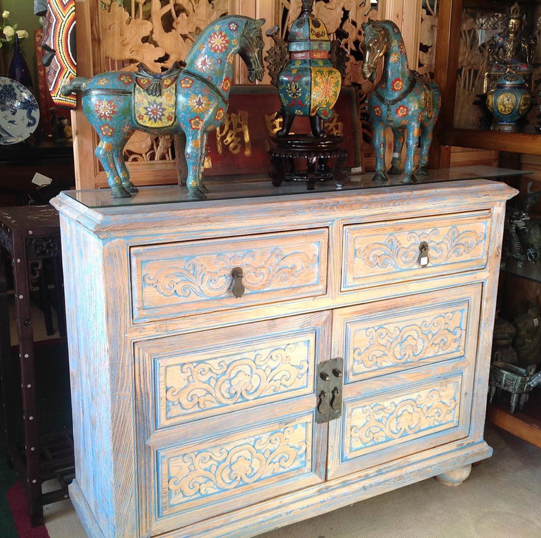 White and blue worn hutch with horse figurines. Photo by Instagram user @goldenlotusinc