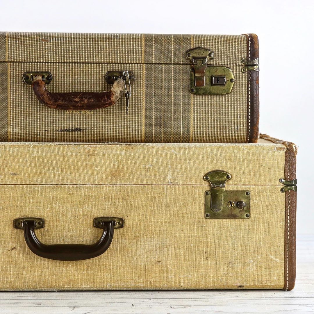 Two brown vintage suitcases stacked. Photo by Instagram user @huntandfound