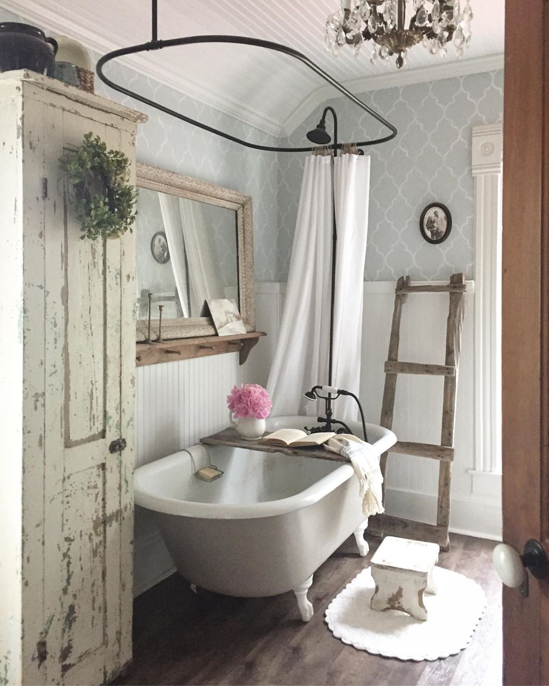 Rustic bathroom with blue wallpaper and big tub. Photo by Instagram user @bryartonfarm