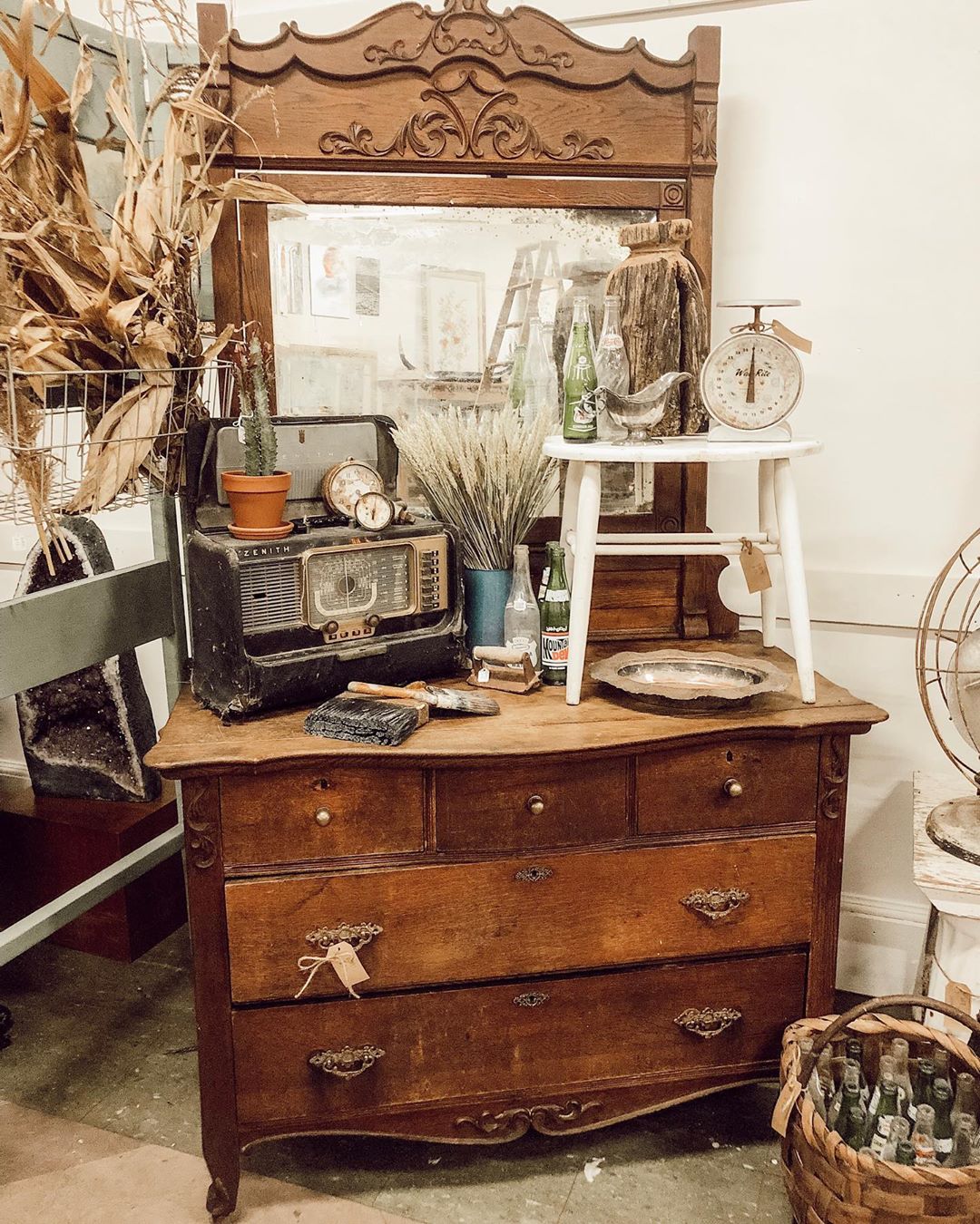 Old brown dresser with antique radio and stool on it. Photo by Instagram user @wattsandcogvl
