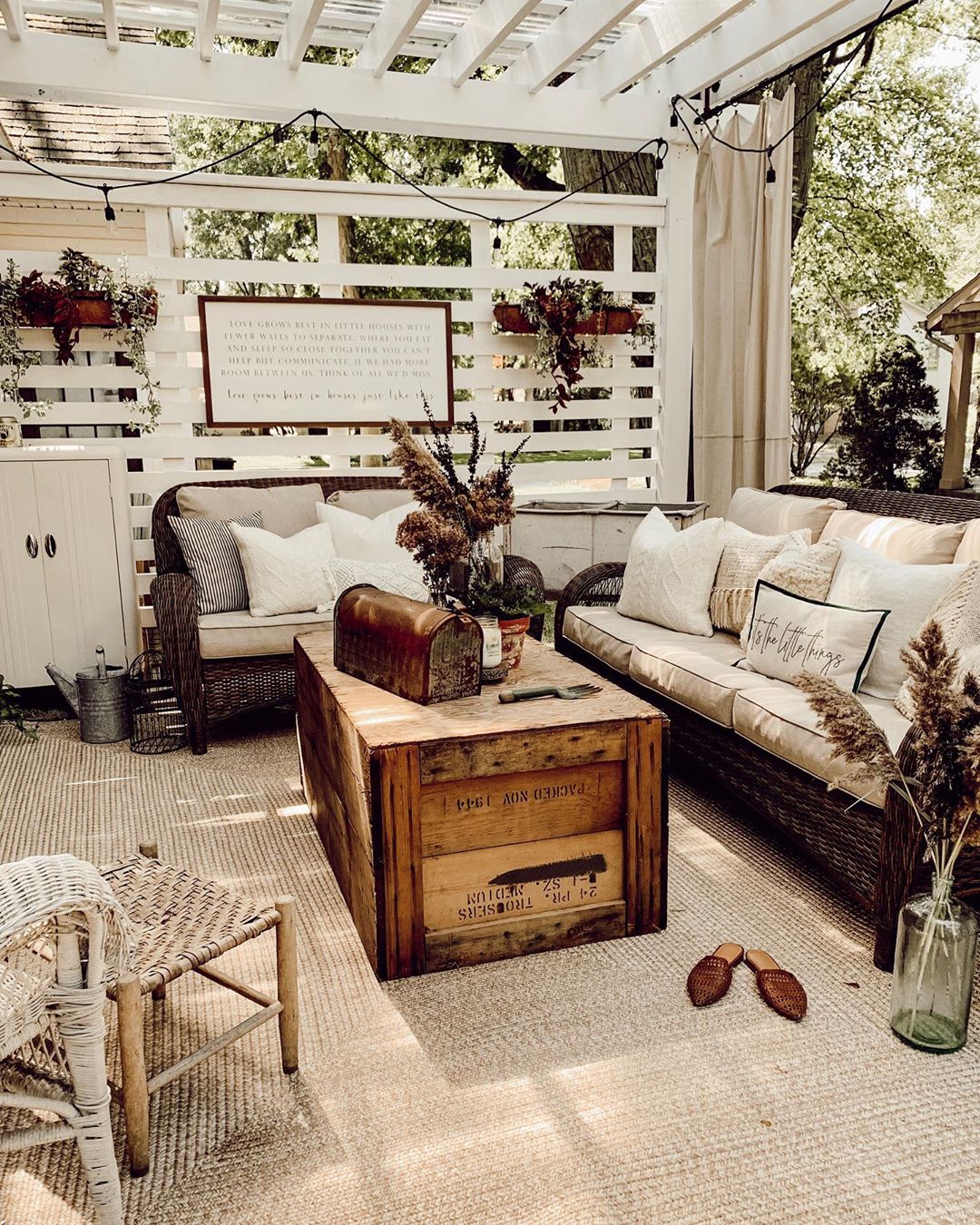 Outdoor patio with tan couches and wooden crate table. Photo by Instagram user @candlewoodcottage