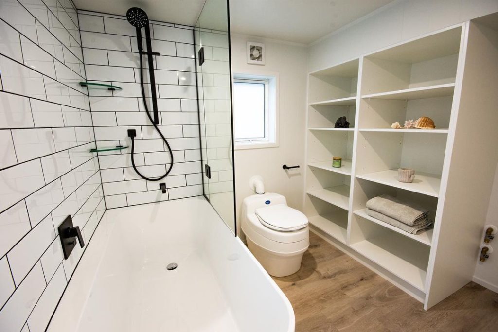 Shelving wall in bathroom. Photo via Instagram user @cocoontinyhomes