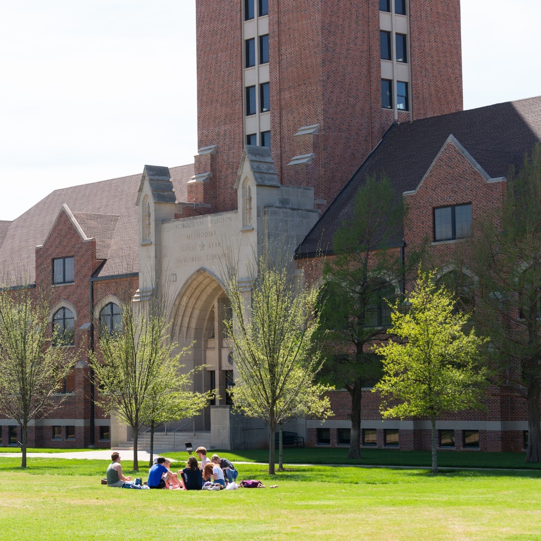 Photo of people sitting outside of an Oklahoma City University building. Photo by Instagram user @oklahomacityuniversity.