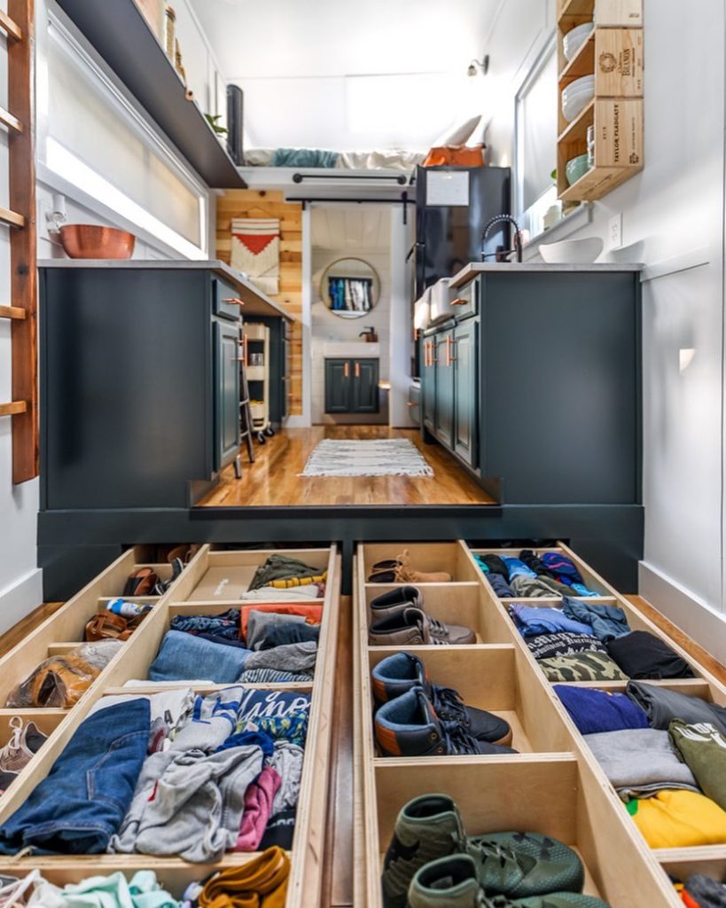 Tiny kitchen with storage in the floor. Photo by Instagram user @livingbiginatinyhouse