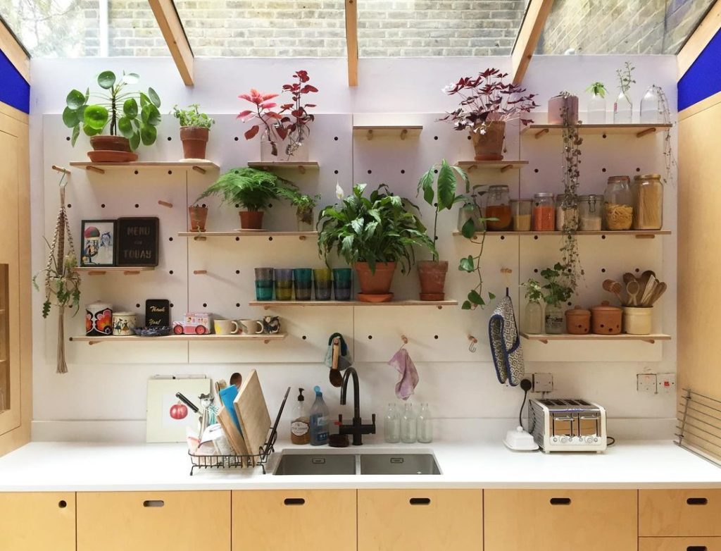 Kitchen pegboard full of plants under sunroof. Photo via Instagram user @kreisdesign