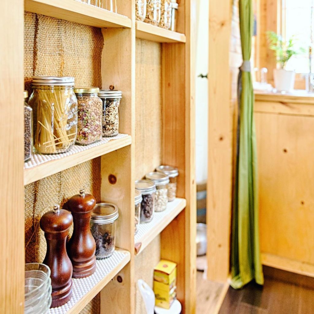 Wall beams used as shelves for spices and dry goods. Photo via Instagram user @tinytackhouse