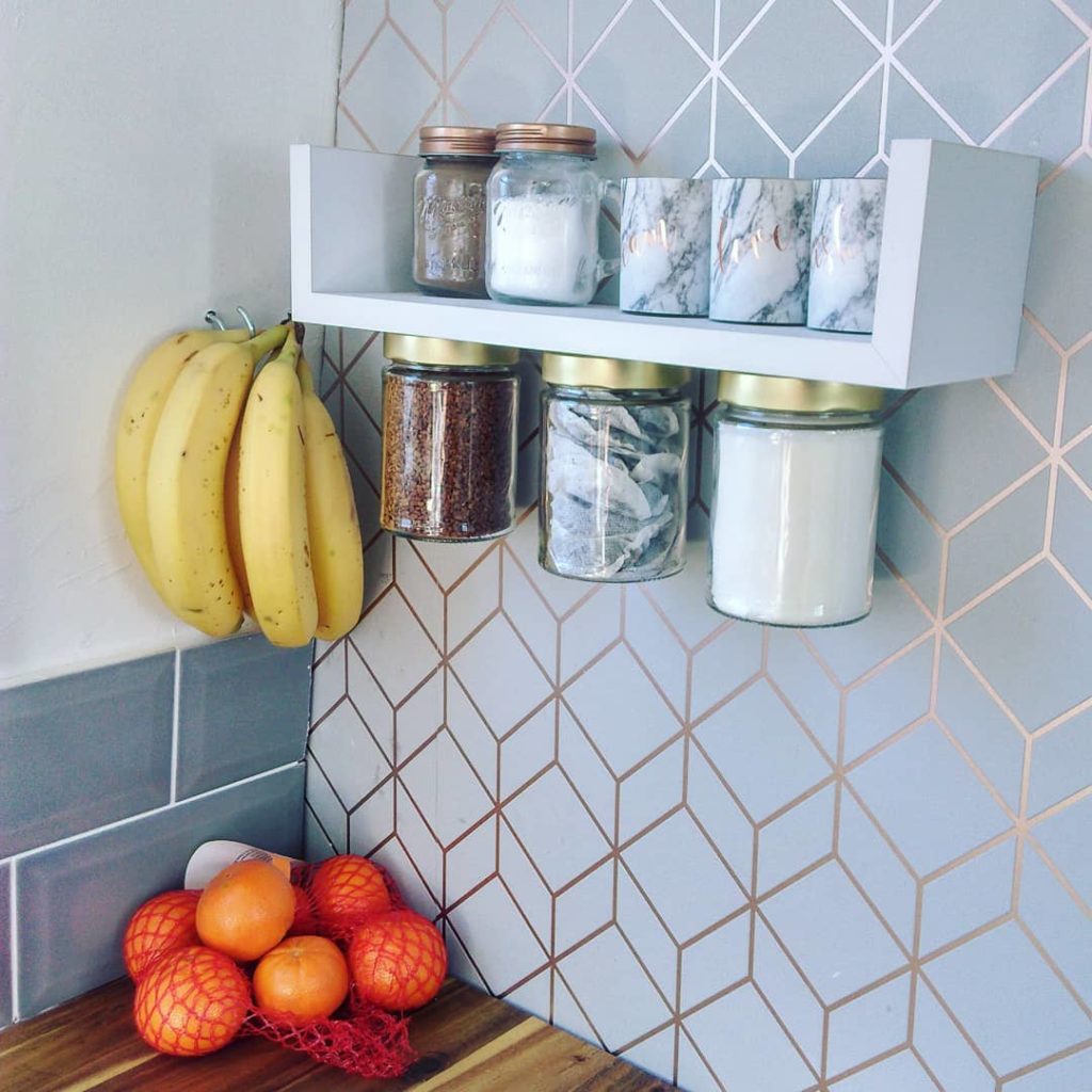Bananas and jars hanging from a two-sided shelf. Photo via Instagram user @5_at_littlejohndrive