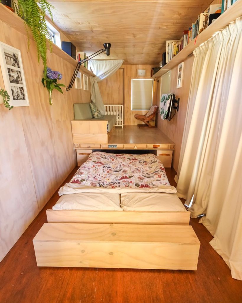 Pull out bed in tiny house. Photo via Instagram user @livingbiginatinyhouse