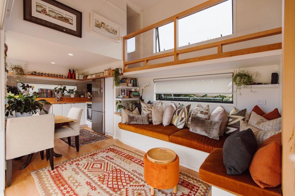 Tiny home interior living and kitchen area. Photo by Instagram user @shayes_tiny_homes