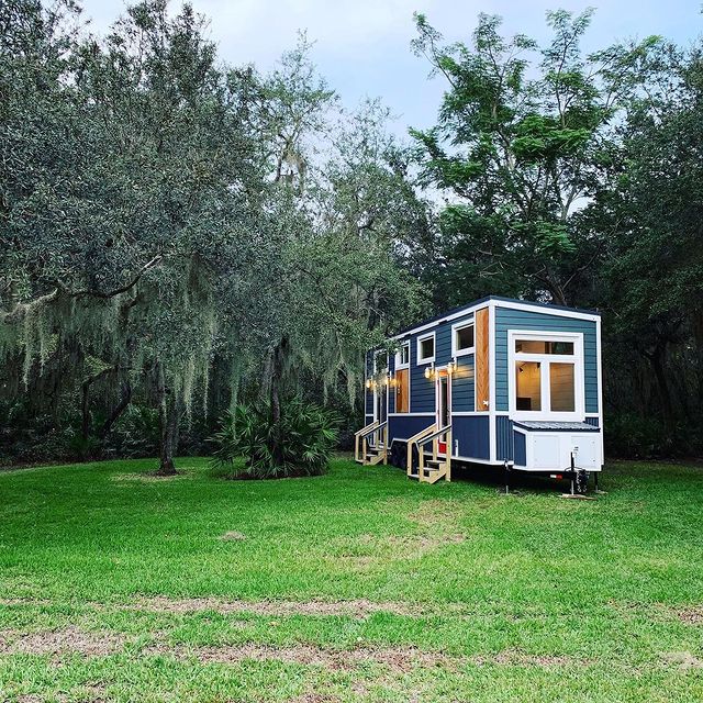 Exterior of a blue tiny house on wheels. Photo by Instagram user @movable_roots