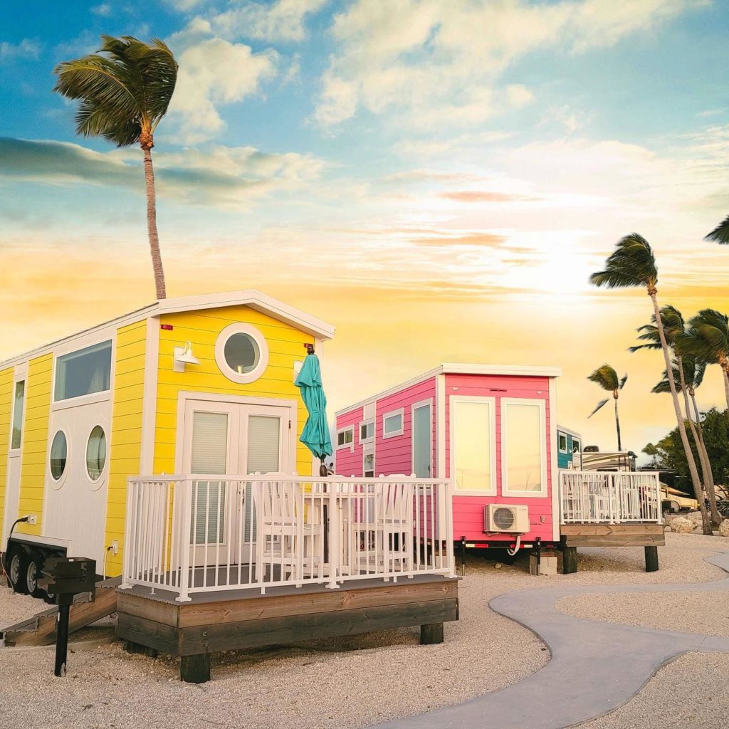 Yellow and pink tiny homes in a tiny house village in Florida. Photo by Instagram user @petite.retreats