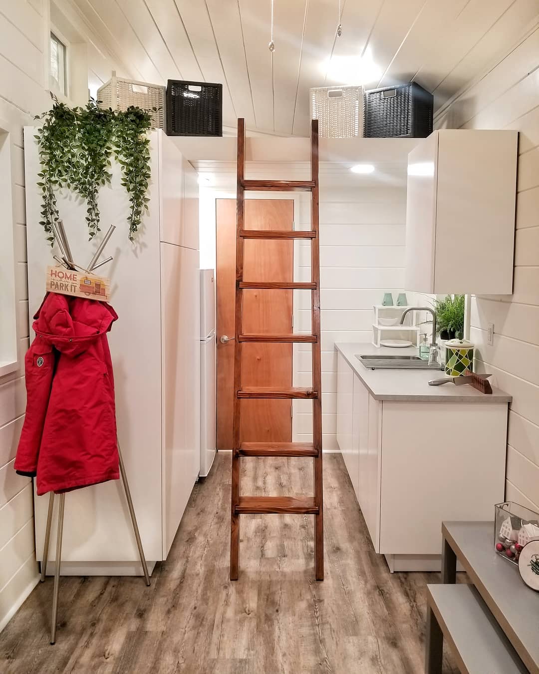 Tiny home with white walls and white cabinets. Photo by Instagram user @backcountrytinyhomes