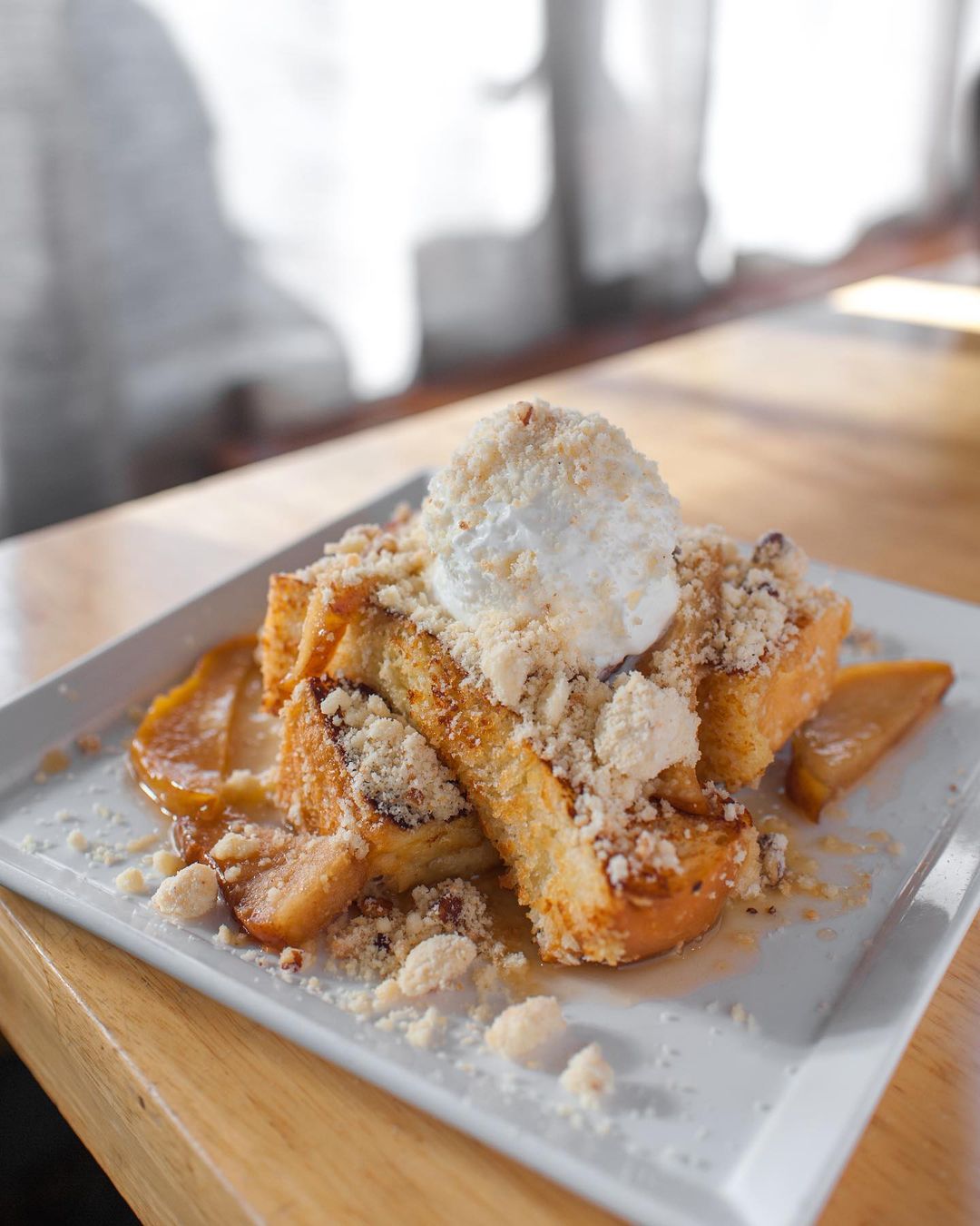 Pear and pecan french toast on a plate at Bacon and Butter Sacramento. Photo by Instagram user @baconandbuttersac.