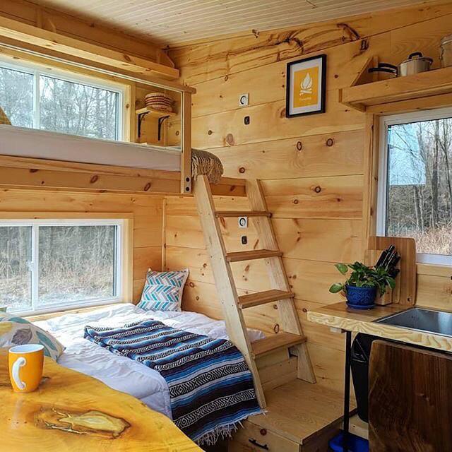 Bunk bed in a tiny home with wood walls. Photo by Instagram user @tinyhouse.minimaison