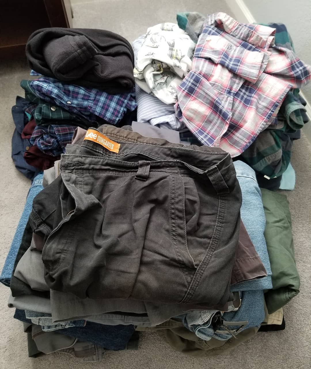 Old clothes folded on floor. Photo by Instagram user @davegregor2018