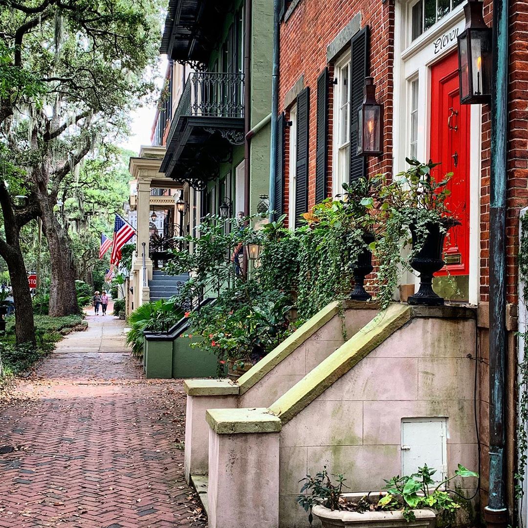 Brick sidewalk by colorful buildings in the Downtown District. Photo by Instagram user @duckdommer